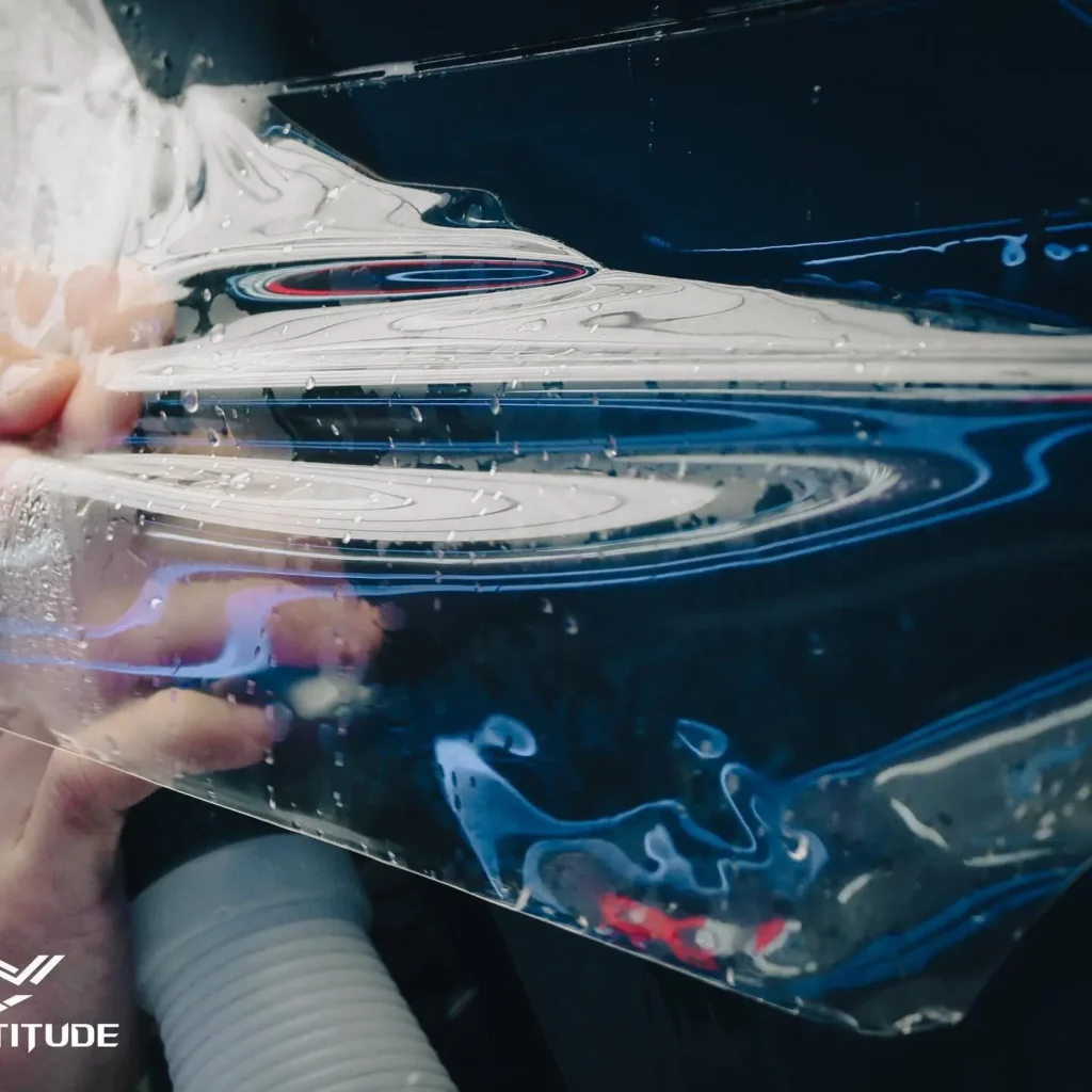 laying paint protection film over vehicle by hand